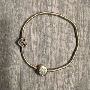 14 carat gold plated Pandora charm bracelet with a heart charm.